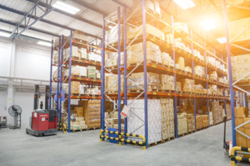 Blur Warehouse inventory product stock for logistic background, Long shelves with a variety of boxes (Lights background)