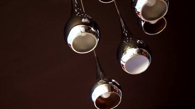 modern beautiful chrome lamp on a dark ceiling