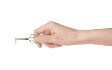 Woman holding bronze vintage ornate key on white background, closeup