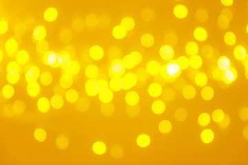 Blurred view of shiny gold lights. Bokeh effect