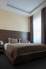 hotel room interior with bed in brown color