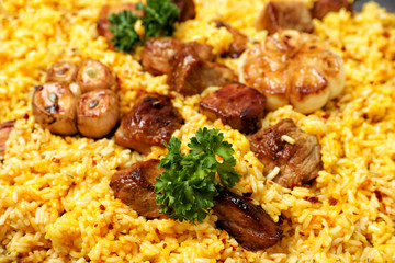 Delicious rice pilaf with meat as background, closeup