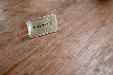 Reserved label the blank menu frameon wooden table cafeteria blurred background can inserting the text.