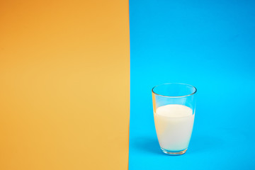glass of milk on a colored background
