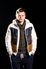 Yong handsome man in night winter forest 