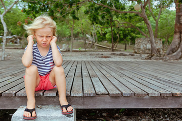 Funny portrait of caucasian kid looking annoyed and unhappy. Upset and angry child concept for...