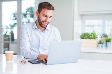 Fototapeta premium Handsome business man working using computer laptop and smiling