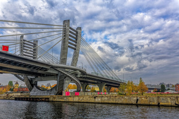 Naklejka premium Central pillar of new Bettencourt bridge on Petrovsky island across the river Malaya (Small) Neva in Saint-Petersburg, Russia at autumn.
