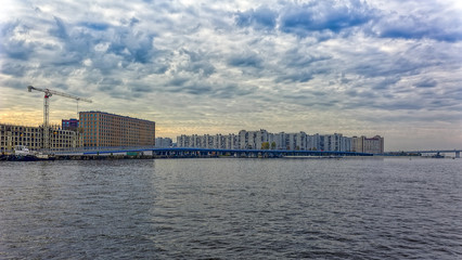 Naklejka premium Autumn panorama of Vasilyevsky island banks at the intersection the Makarov Embankment with the Western Speed Diameter in Saint-Petersburg, Russia.