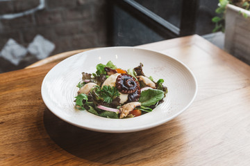 Smoked Galician Octopus with Burrata Cheese, radish, green oak and tomato.