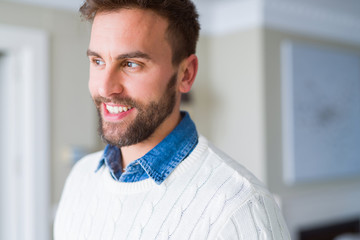 Handsome man smiling positive at the camera