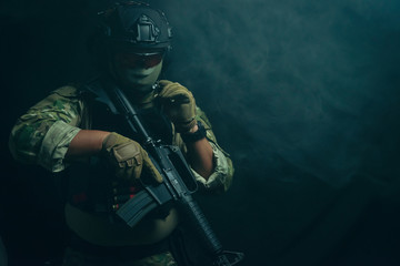 Spec ops police officer in black uniform on a studio background