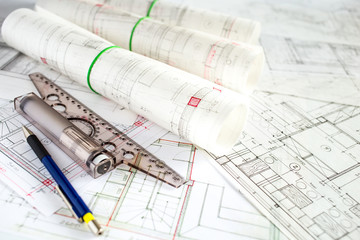 Architect workplace. Architectural project, blueprints, blueprint rolls on wooden desk table. Construction background. Engineering tools. Copy space