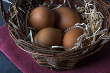 Easter basket with eggs, shot on a dark background