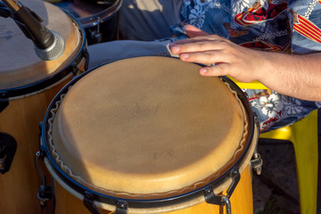 Detail of man playing atabaque during party at the carnival of the city of Belo Horizonte, Minas...