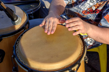 Detail of man playing atabaque during party at the carnival of the city of Belo Horizonte, Minas...