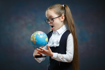 Amazed Little Blond Schoolgirl Look at World Globe