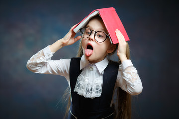 Fototapeta na wymiar Bored Schoolgirl Play Ape Hold Open Book on Head