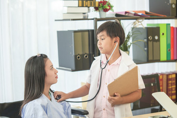 Fototapeta premium Doctor boy are check the woman patient sit on wheelchair by medical stethoscope in the hospital