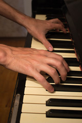 Obraz premium Close up of young boy hands, playing piano. vintage piano