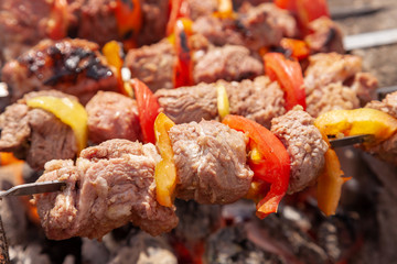 grilled meat skewers over charcoal closeup