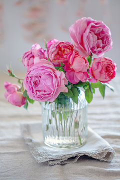 Delicate beautiful pink roses from a garden in a glass vase. English Roses,Variety - Princess Alexandra of Kent.
