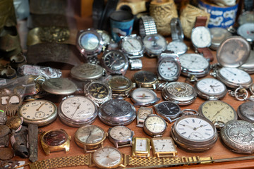 vintage pocket and wrist watches are on the shelf