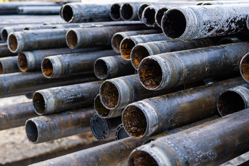 Offshore Industry oil and gas production petroleum pipeline. Downhole drilling rig. Laying the pipe on the deck. View of the shell of drill pipes laid in courtyard of the oil and gas warehouse.