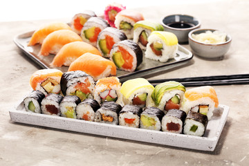 close up of sashimi sushi set with chopsticks and soy - sushi roll with salmon and sushi roll with smoked eel