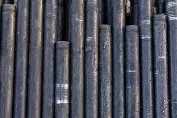 Offshore Industry oil and gas production petroleum pipeline. Downhole drilling rig. Laying the pipe on the deck. View of the shell of drill pipes laid in courtyard of the oil and gas warehouse.