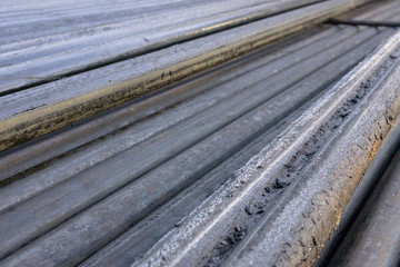 Offshore Industry oil and gas production petroleum pipeline. Downhole drilling rig. Laying the pipe on the deck. View of the shell of drill pipes laid in courtyard of the oil and gas warehouse.