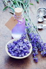 Obraz na płótnie Canvas Aromatherapy oil and lavender, lavender spa, Wellness with lavender, lavender Scented stones lavender syrup on a wooden background