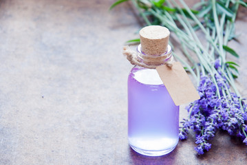 Obraz na płótnie Canvas Aromatherapy oil and lavender, lavender spa, Wellness with lavender, lavender syrup on a wooden background