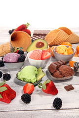Set of ice cream scoops of different colors and flavours with berries, chocolate and fruits.