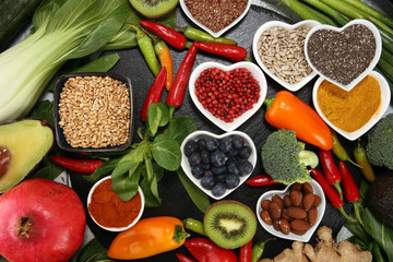 Healthy food clean eating selection. fruit, vegetable, seeds, superfood, cereals, leaf vegetable on rustic background