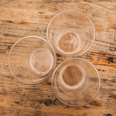 Empty plastic cups on wooden desk in triangle