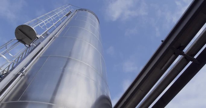 Gigantic industrial silo reaching into the blue sky