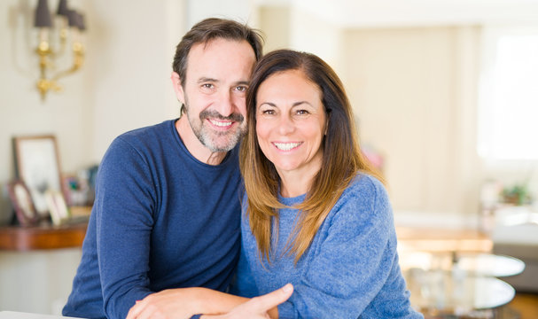 Romantic middle age couple sitting together at home