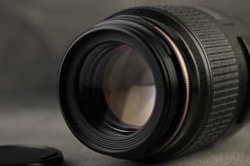 Lens for digital SLR cameras on a gray cement background.