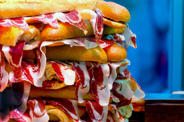 tower of spanish ham sandwhiches in a shop