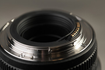 Fototapeta na wymiar Lens for digital SLR cameras on a gray cement background.