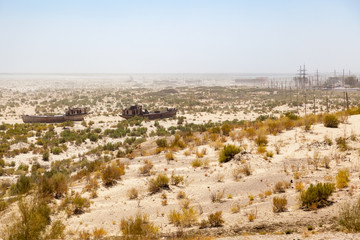 Obraz premium Rustic boats on a ship graveyards on a desert around Moynaq, Muynak or Moynoq - Aral sea or Aral lake - Uzbekistan in Central Asia