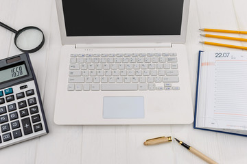 Top view at workplace, laptop, diary, pencil