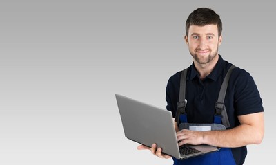 Portrait of cheerful Handsome  mechanic  on background