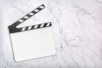 Blank clapboard on white marble background. White clapper board template. Flat lay