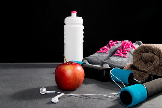 Pair of sport shoes, apple, meetr and towel on red background. Copy space. Flat lay &ndash; image