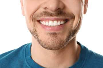 Fototapeta premium Smiling man with perfect teeth on white background, closeup