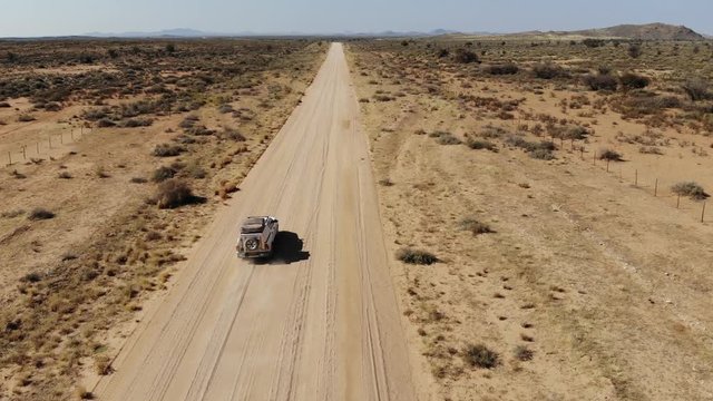 4x4 offroad vehicle driving on dirt track in Khomas Highland, close to Gamsberg and Spreetshoogte Pass, Namibia, Aerial drone shot