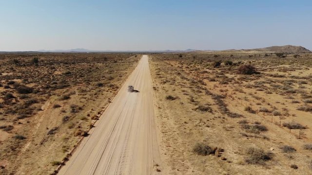 4x4 offroad vehicle driving on dirt track in Khomas Highland, close to Gamsberg and Spreetshoogte Pass, Namibia, Aerial drone shot