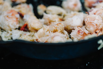 Close up of lobster meat cooking in a frying pan